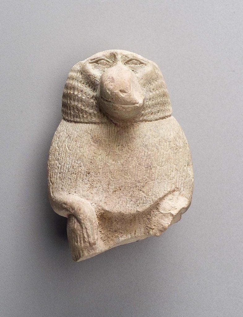 Finely shaped and incised upper part of statuette of Thoth as baboon 