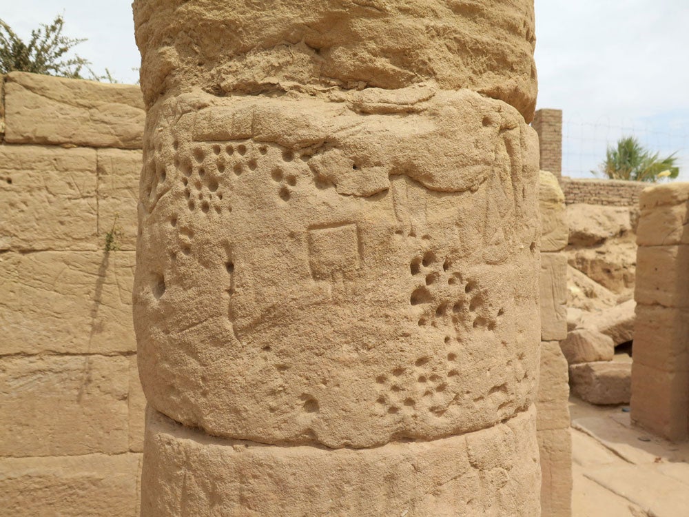 carved graffiti on a sandstone column