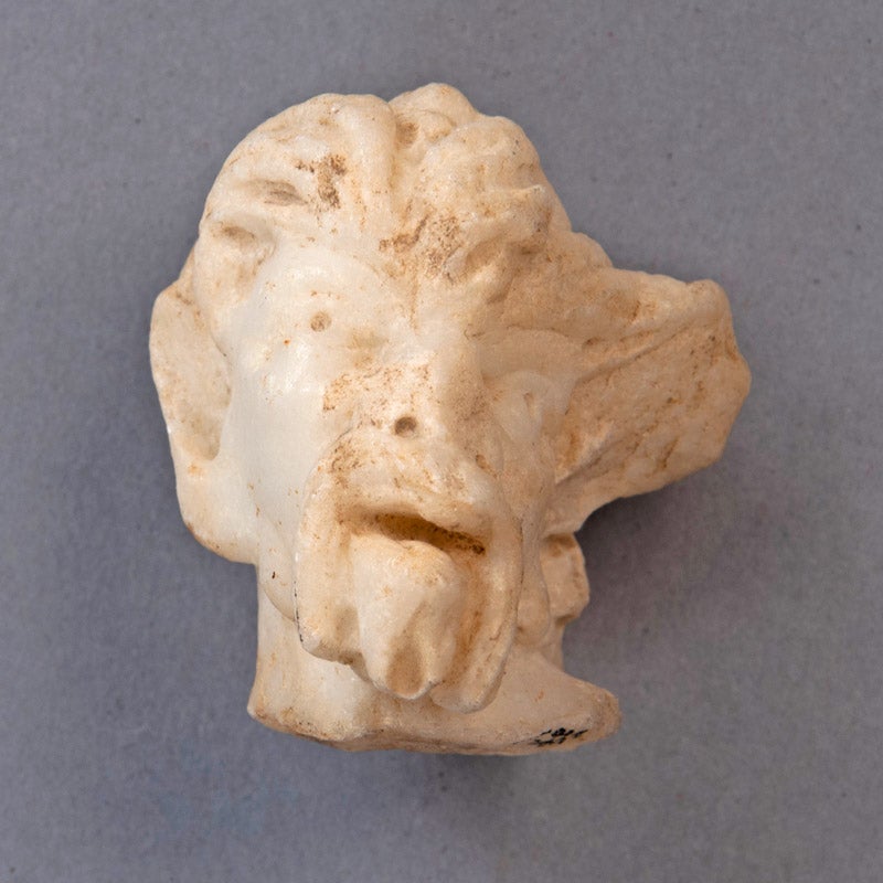 photo of a marble head of a faun