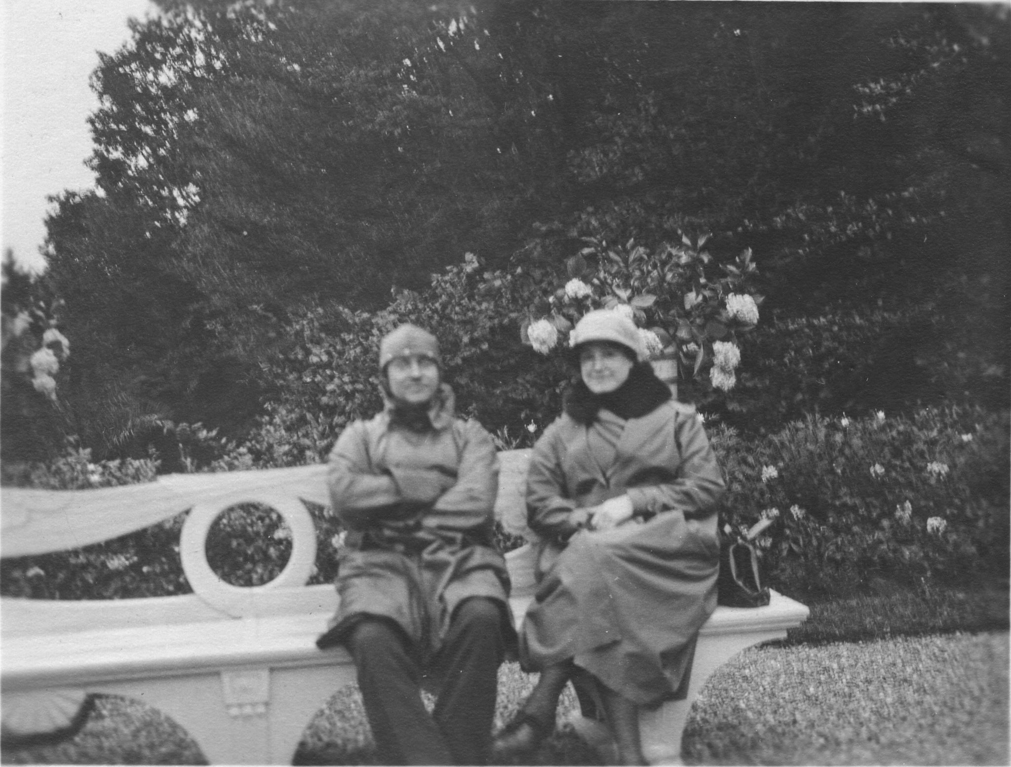 black and white photo of man and woman on a bench