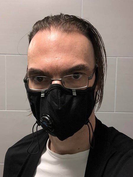Selfie photo of Scott with long hair and a mask.