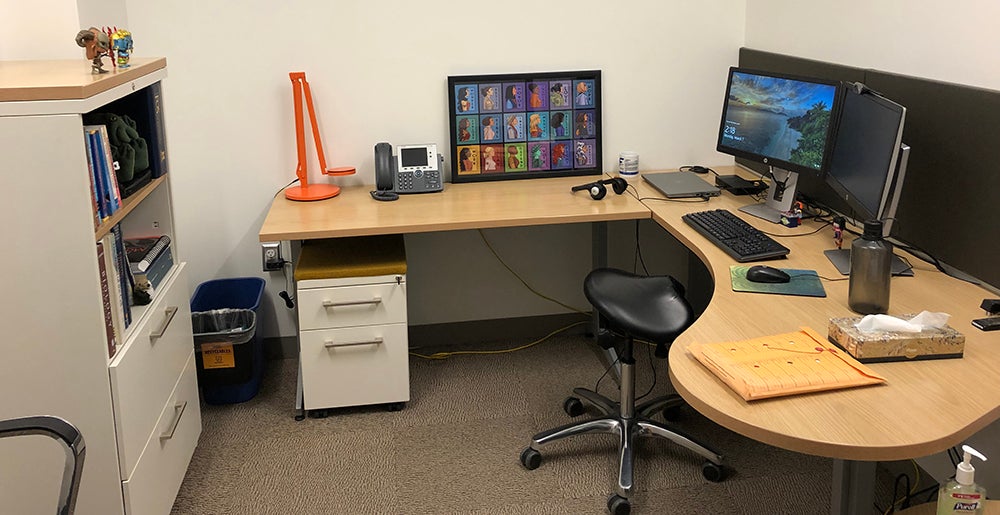 Scott's new office, with desk, shelf, and miscellanous art