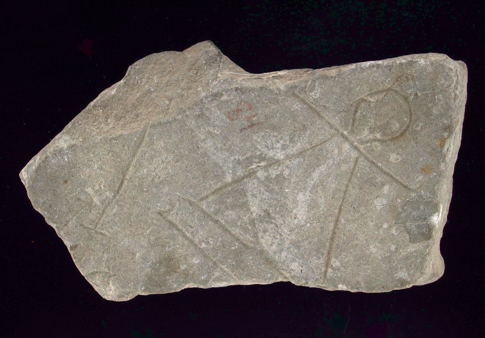 fragment of rock with etched shape of a woman.
