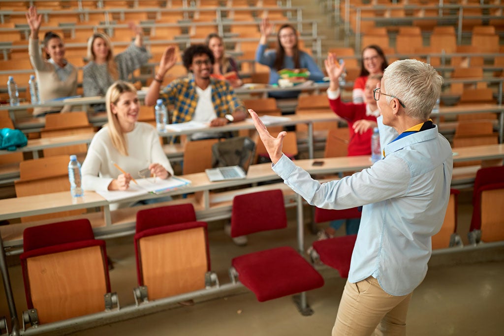 lecturer in university - students listening to teacher in the classroom on college.