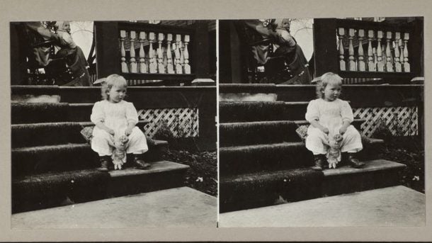 Child sitting on steps with doll