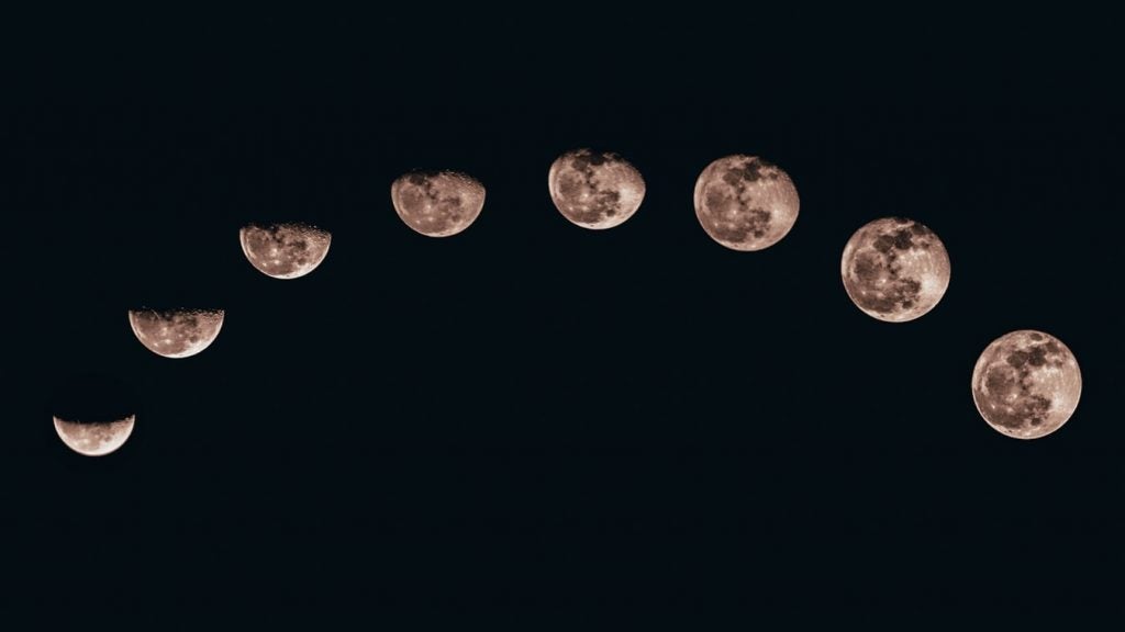Moon phases against black background