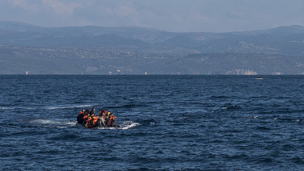 group of people on a deflatable boat in the sea
