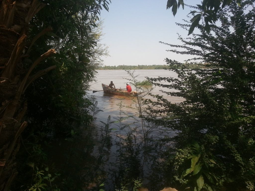 Two men in a boat on the flooded Nile.