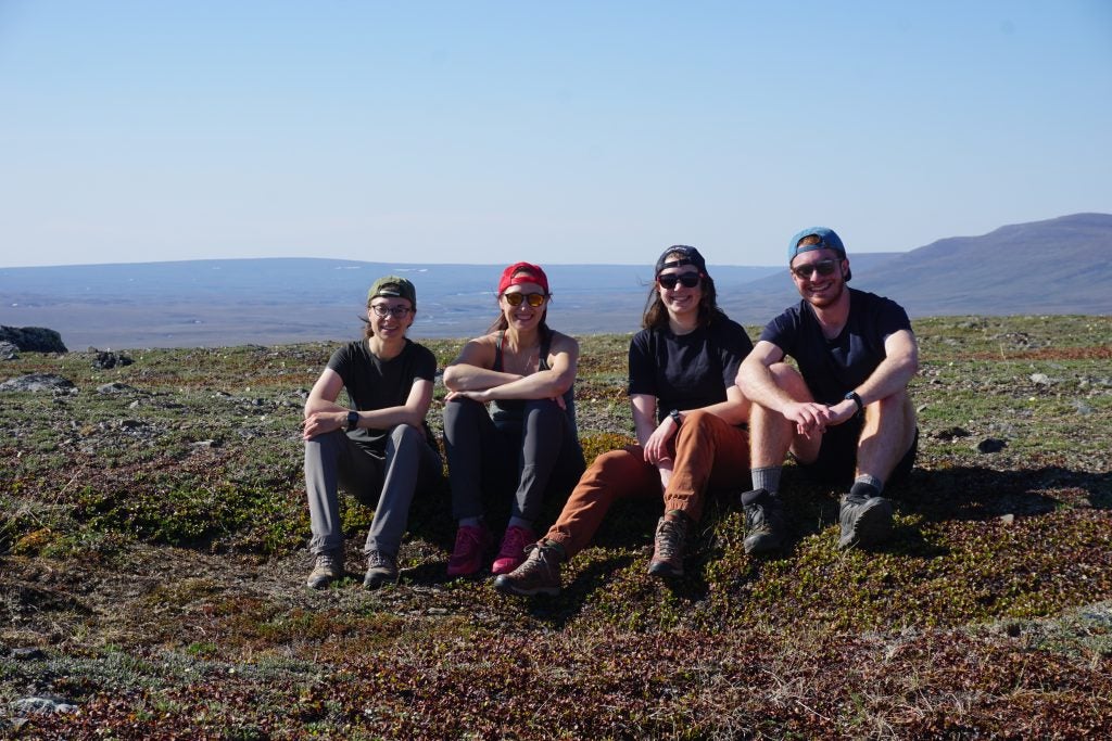 Cory lab group 2022 sitting on the Tundra after a fun hike in the Arctic