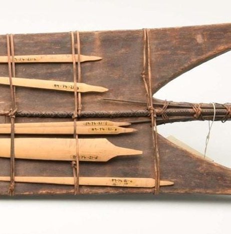 The back view of the shield. It features several wooden spearheads attached by rattan wrapping around the shield.